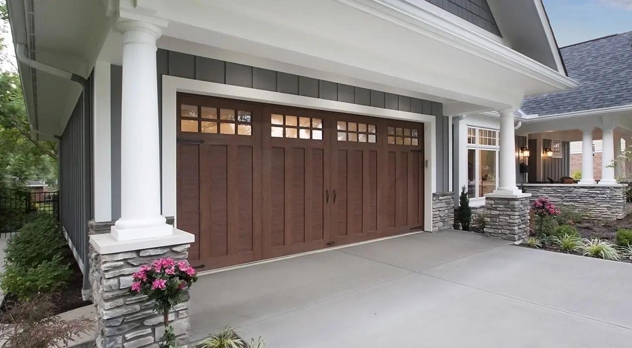 Clopay Canyon Ridge carriage house garage door with faux wood composite overlay and decorative hardware accents