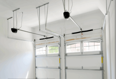 Technician repairing and realigning residential garage door tracks