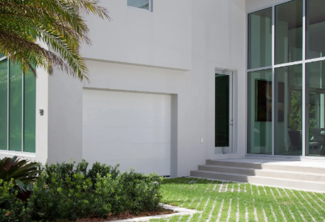 Modern Haas aluminum and glass garage door on contemporary house.